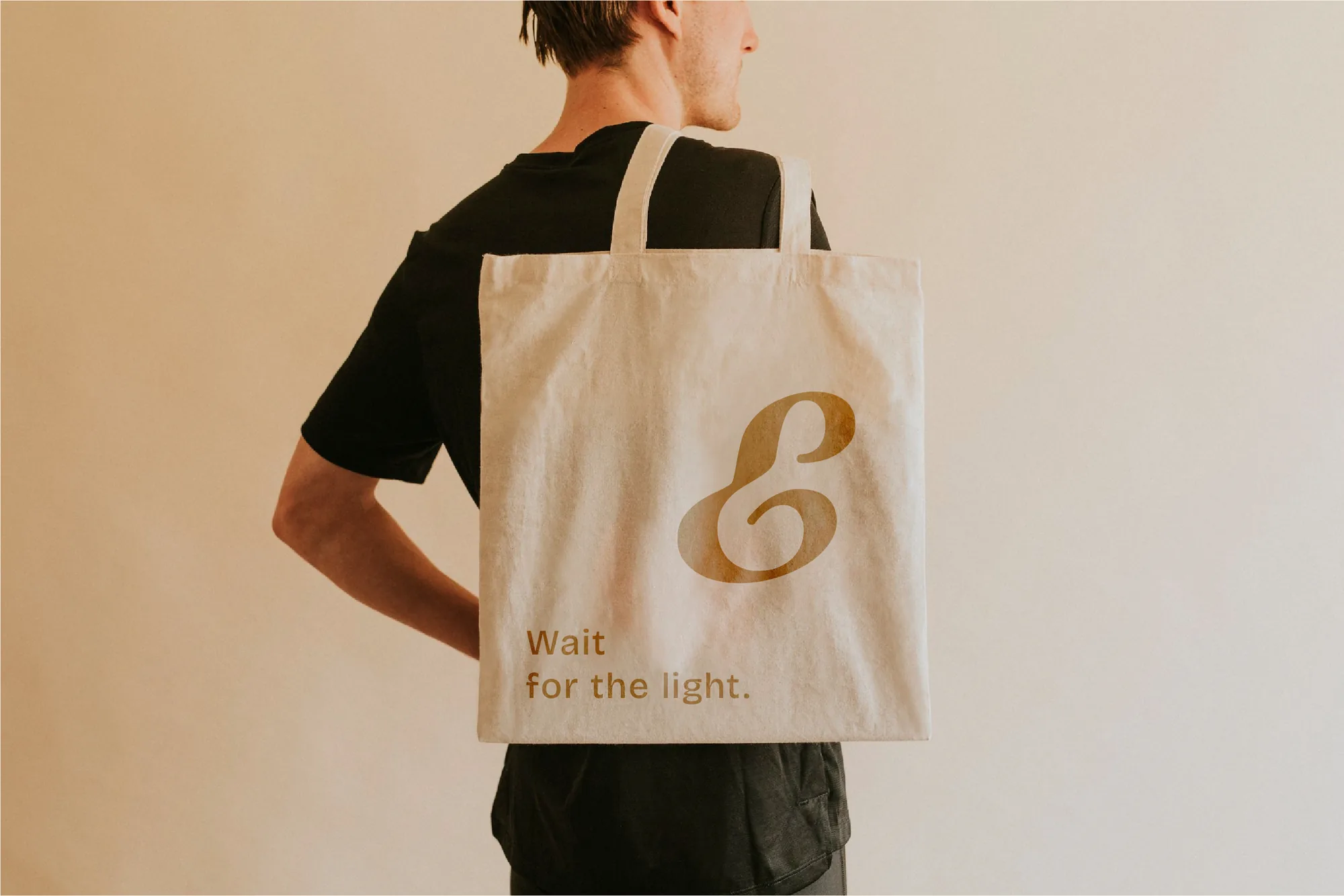 A canvas tote bag with a large Bronze icon and the line 'Wait for the light.'