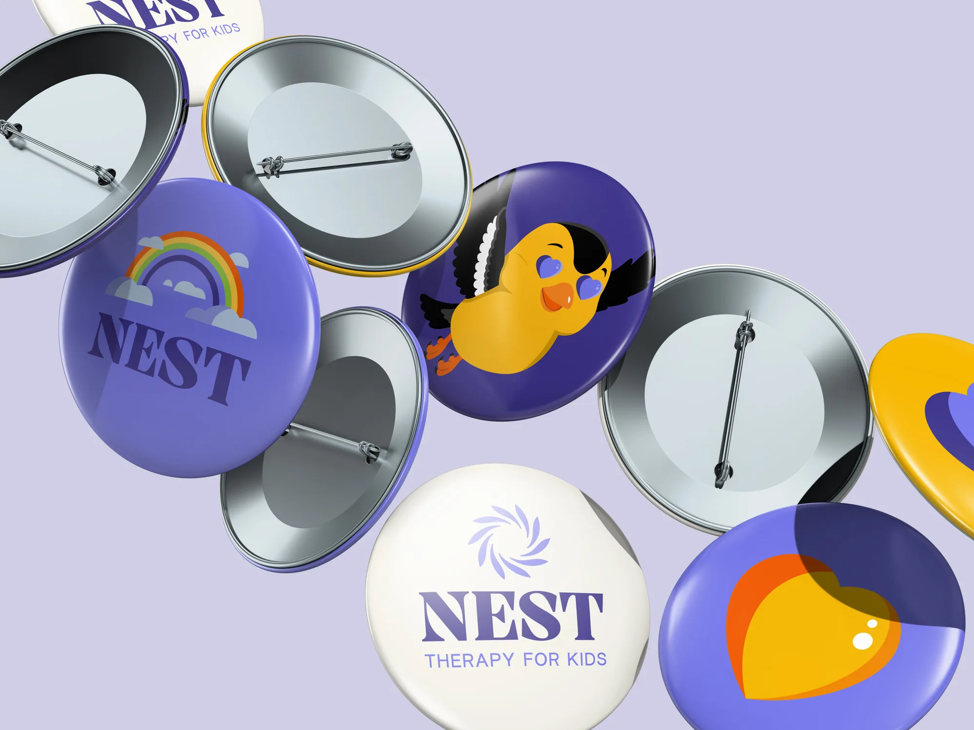 Round pin badges with the Nest logo, the mascot and brand colors
