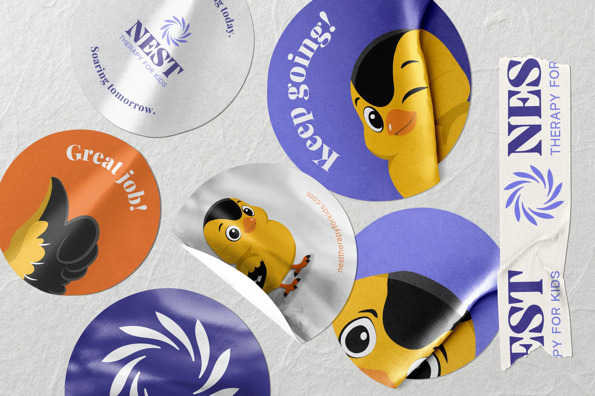 Round stickers with the logomark, the mascot and lines like 'Keep going!' and 'Great job!'
