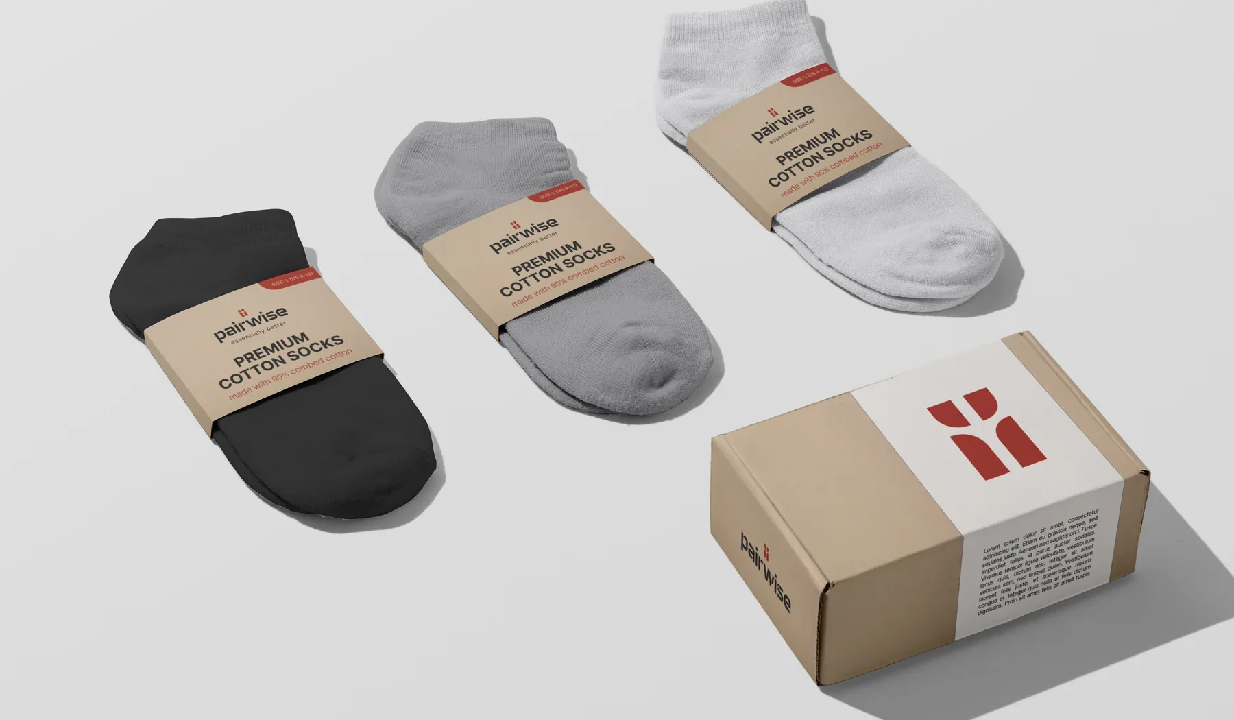 Three sock colorways in kraft sleeves, black, grey and white, beside the shipping box