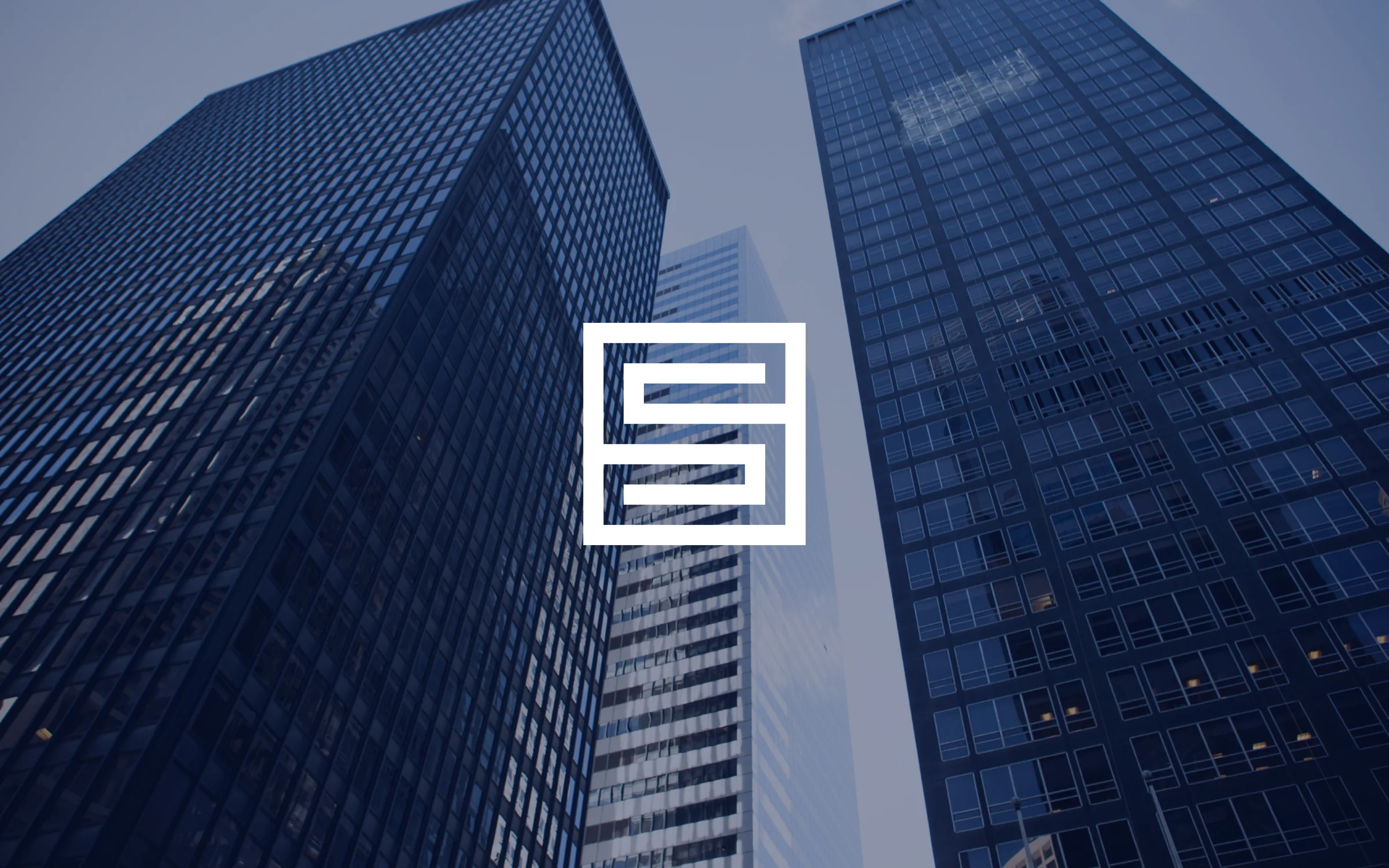 Looking up at glass office towers, with the Safer Gambling Strategies logomark centered between them