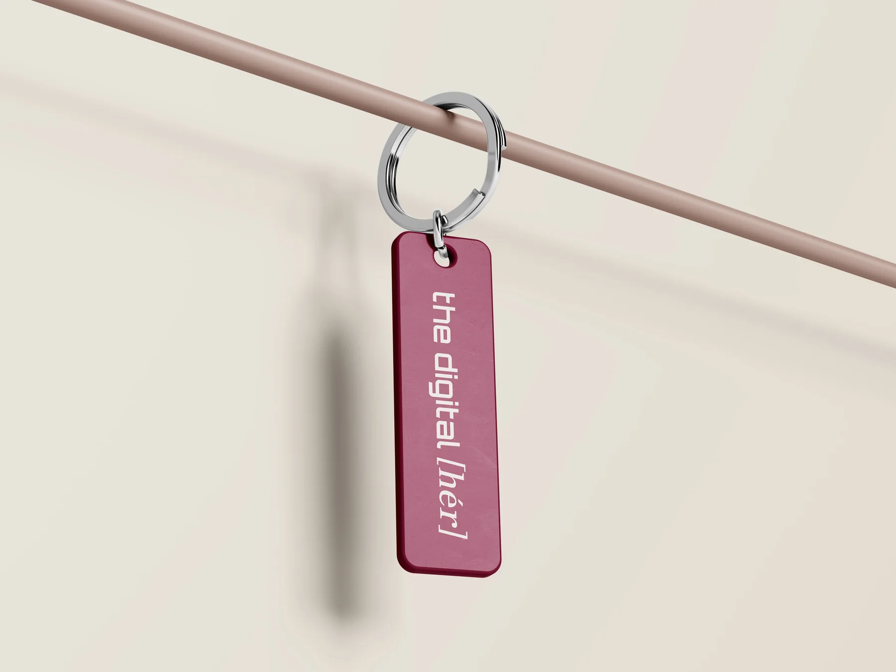 A rosewood keychain tag with the wordmark engraved in white